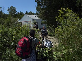 At the end of Roxham Rd. in Champlain, Fiyori Mesfin, 32, crosses into Canada with her three-year-old son and one-year-old daughter, both U.S. citizens.