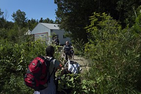 At the end of Roxham Road in Champlain, Fiyori Mesfin, 32, crosses into Canada with her 3-year-old son and 1-year-old daughter, both U.S. citizens. She had been living in Las Vegas for four years but was denied asylum status. (Andre Malerba/The Washington Post)