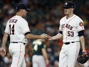 Manager AJ Hinch of the Houston Astros takes the ball from Ken Giles in the ninth inning against the Oakland Athletics at Minute Maid Park on July 10, 2018 in Houston. (Bob Levey/Getty Images)