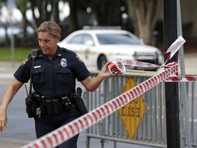 A Jacksonville police officer blocks off an area Monday, Aug. 27, 2018, near the scene of a fatal shooting at The Jacksonville Landing on Sunday in Jacksonville, Fla.