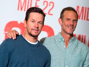 Actor Mark Wahlberg and director Peter Berg pose during a photo call for Mile 22 in Beverly Hills, Calif. VALERIE MACON/AFP/Getty Images