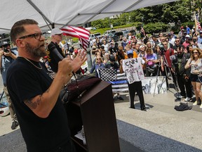 Gavin McInnes (L) speaks to activists as they take part in the "March Against Sharia" on June 10, 2017 in New York City. The Vice Media co-founder "was silenced on Twitter recently for absolutely no good reason and remains suspended," Michelle Malkin writes.