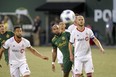 Portland Timbers' Samuel Armenteros watches the ball as he stands between Toronto FC's Michael Bradley (4) and Justin Morrow (2) during an MLS soccer match Wednesday, Aug. 29, 2018, in Portland, Ore. (Sean Meagher/The Oregonian via AP)