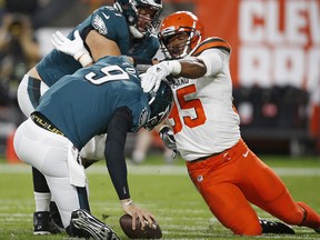 Cleveland Browns defensive end Myles Garrett (95) takes down Philadelphia Eagles quarterback Nick Foles (9) for a safety Thursday, Aug. 23, 2018, in Cleveland. (AP Photo/Ron Schwane)