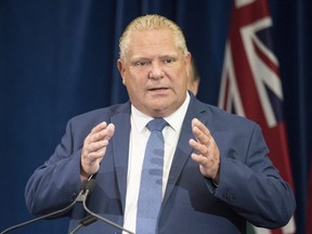 Ontario Premier Doug Ford stands at the podium during a press announcement at the Queens Park Legislature in Toronto on Thursday, August 9, 2018. THE CANADIAN PRESS/Chris Young