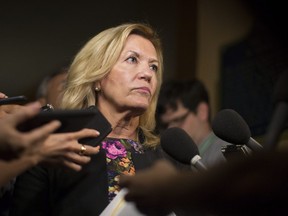 Ontario Deputy Premier Christine Elliott talks with journalists following Question Period at the Ontario Legislature in Toronto on Wednesday, August 1, 2018.THE CANADIAN PRESS/Chris Young