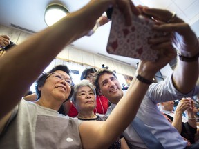 Prime Minister Justin Trudeau, right, poses for a selfie in Richmond Hill, Ont., on Friday, July 20, 2018. (Nathan Denette/The Canadian Press)