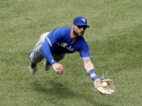 Toronto Blue Jays centre fielder Kevin Pillar makes a diving catch on Boston Red Sox's Brock Holt Saturday, July 14, 2018, in Boston. (AP Photo/Winslow Townson)