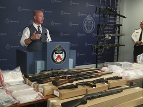 Acting Insp. Steve Watts shows off some of dugs and weapons confiscated in Project Switch at Toronto Police Headquarters on Thursday August 2, 2018. (Jack Boland/Toronto Sun/Postmedia Network)