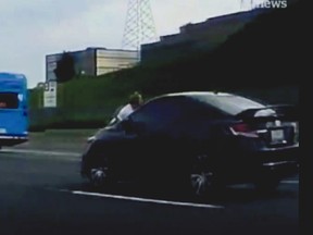 A dashcam video of David Yeomans clinging to the hood of a car as it drove along Hwy. 404, near Finch Ave., at upwards of 100 km/h, an ordeal sparked by road rage between two motorists on Wednesday, Aug. 29, 2018. (image from video posted by CBC on Twitter)
