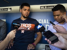 Astros relief pitcher Roberto Osuna is interviewed in the dugout before a game against the Dodgers in Los Angeles, Sunday, Aug. 5, 2018.