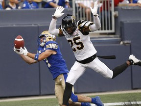 Through nine games, Ticats cornerback Rolle (right) leads the team in picks with two and has 21 tackles, more than anyone else in the Ticats secondary other than safety Mike Daly. (The Canadian Press)