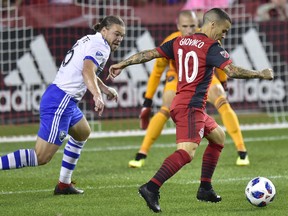 Toronto FC forward Sebastian Giovinco (10) scores on Montreal Impact goalkeeper Evan Bush (1) for his second goal of the game as Samuel Piette (6) defends during first half MLS soccer action in Toronto on Saturday. Frank Gunn/The Canadian Press