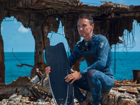 Filmmaker Rob Stewart sits among the ribs of the wreck of the Spona in Bimini before a dive for Sharkwater: Extinction. (Handout photo)