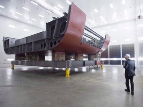 Kevin McCoy, president of Irving Shipbuilding, leads a tour as workers construct components of the Arctic offshore patrol ships at their facility in Halifax on Friday, March 4, 2016.