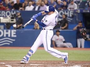 Jays’ Justin Smoak hits an RBI single against the Boston Red Sox last night. (Getty Images)