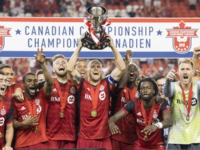 Toronto FC captain Michael Bradley lifts the Voyageurs Cup after beating Vancouver Whitecaps 5-2 to win the Canadian Championship Final, in Toronto on Wednesday, August 15, 2018. THE CANADIAN PRESS/Chris Young ORG XMIT: CHY113