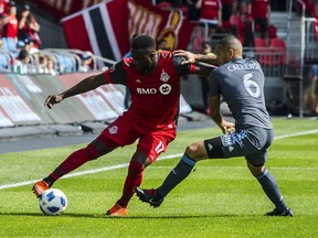 Toronto FC forward Jozy Altidore (17) and New York City FC defender Alexander Callens (6) fight for the ball early in the first half  at BMO Field on Sunday, August 12, 2018. Moments later, Altidore was red-carded. THE CANADIAN PRESS/Christopher Katsarov