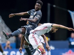 Vancouver Whitecaps' Alphonso Davies, left, and Toronto FC's Jonathan Osorio collide during first half Canadian Championship soccer final action in Vancouver on Wednesday, August 8, 2018. THE CANADIAN PRESS/Darryl Dyck ORG XMIT: VCRD219