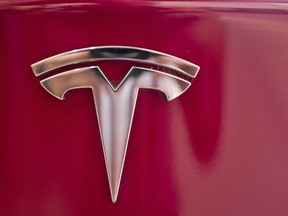 A Tesla emblem is seen on the back end of a Model S in the Tesla showroom in Santa Monica, Calif., on Wednesday, Aug. 8, 2018.  THE CANADIAN PRESS/AP-Richard Vogel