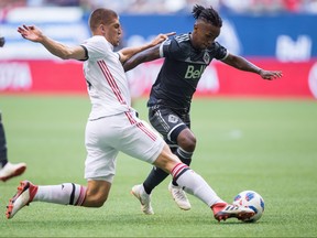 Toronto FC's Nick Hagglund (left) defends against Vancouver Whitecaps' Yordy Reyna during the first half of the first leg of the Canadian Championship final in Vancouver on Wednesday night. THE CANADIAN PRESS
