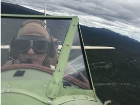 Pilot Kelly Collins came out of retirement after he heard Great River Air was planning to fly tourists in a 1942 biplane over the Dawson City gold fields. He's seen here over Whitehorse, Yukon.