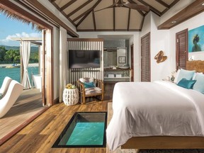 Bungalow interiors are pure Caribbean chic with vaulted ceilings and views of water and sky from every angle, including a window in the floor that looks down on the ocean below. SANDALS RESORTS PHOTO