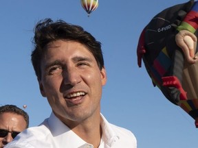 Prime Minister Justin Trudeau works the crowd as he attends the the International Balloon Festival in St-Jean-sur-Richelieu, Que., on Thursday, August 16, 2018.