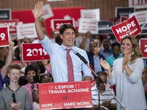 Prime Minister Justin Trudeau is applauded by his wife, Sophie Gregoire, and supporters during his nomination meeting in Montreal on Sunday, Aug. 19, 2018.