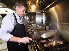 Mayor John Tory mans the grill at Apache Burger as he kicks off his re-election campaign on Wednesday. (Veronica Henri/Toronto Sun)