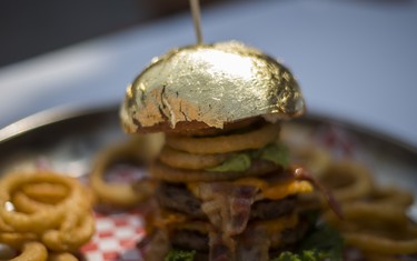 The  Golden Burger  - from Bacon Nation - with an edible gold bun for $100 - at the CNE Media Preview at Exhibition Place in Toronto, Ont. on Wednesday August 15, 2018. The Canadian National Exhibition runs from August 17 to September 3. Ernest Doroszuk/Toronto Sun/Postmedia