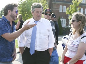 Mayor John Tory talks  with Scott Rondeau (L) and Julie Steel during a barbecue raising money for the Reese Fallon Legacy Scholarship on Wednesday August 22, 2018. (Veronica Henri/Toronto Sun)