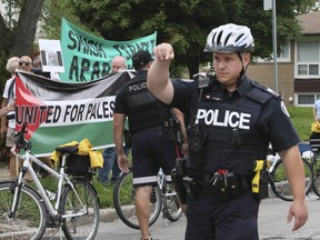 Police keep protestors apart in front of a Bnai Brith building in North York on Wednesday. (Veronica Henri/Toronto Sun)
