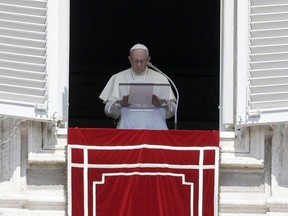 FILE - In this Sunday, Aug. 19, 2018 file photo, Pope Francis prays for the victims of the Kerala floods during the Angelus noon prayer in St.Peter's Square, at the Vatican. Pope Francis has issued a letter to Catholics around the world condemning the "crime" of priestly sexual abuse and cover-up and demanding accountability, in response to new revelations in the United States of decades of misconduct by the Catholic Church.