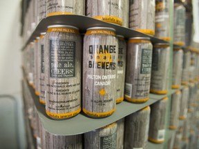 Cans of Orange Snail Brewers craft beer line the shelves in Milton, Ont. on Tuesday (Ernest Doroszuk/Toronto Sun)