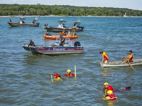 Toronto Police Marine Unit boats, Toronto Fire staff, a Canadian Coast Guard rescue boat, an RCAF helicopter and 10 to 15 lifeguards search Lake Ontario just off the shore at Woodbine Beach to ensure a group of swimmers who were distress in the water were all accounted for in Toronto, Ont. on Friday, Aug. 10, 2018. (Ernest Doroszuk/Toronto Sun/Postmedia)