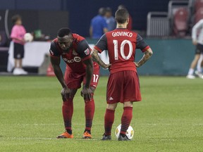 Toronto FC's Jozy Altidore (left) and Sebastian Giovinco stand at the centre circle waiting to restart the game after Los Angeles FC's Diego Rossi scored his team's second goal on Sunday. (THE CANADIAN PRESS)