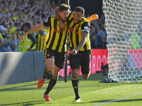 Watford's Craig Cathcart (left) celebrates with Troy Deeney after scoring the game-winning goal against Tottenham Hotspur on Sunday. (GETTY IMAGES)