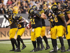 Hamilton Tiger-Cats players do a dance in the end zone to celebrate a touchdown by Hamilton Tiger-Cats wide receiver Brandon Banks (second from left). (THE CANADIAN PRESS)