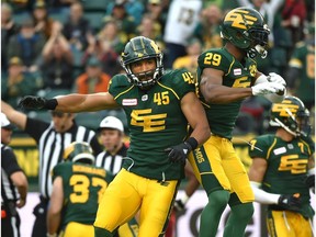 Edmonton Eskimos Korey Jones (45) and Mercy Maston (29) celebrate a fumble recovery against the Calgary Stampeders /c during CFL action at Commonwealth Stadium in Edmonton, September 8, 2018.