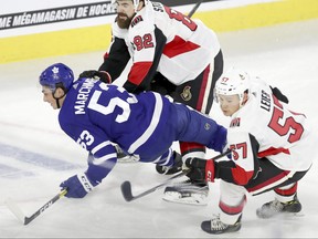 Maple Leafs Mason Marchment is knocked Ottawa Senators Chase Stewart and Boston Leier during their Rookie Showdown game in Laval on Saturday September 8, 2018. (John Mahoney / Postmedia