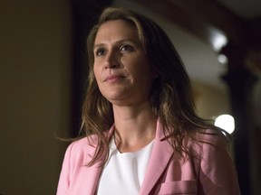 Caroline Mulroney, Attorney General of Ontario, walks away after scrumming with reporters at the legislature in Toronto, on Wednesday, September 12, 2018. THE CANADIAN PRESS/Chris Young