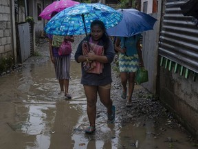 Residents evacuate to safer grounds as Typhoon Mangkhut approaches on September 14, 2018 in Tuguegarao city, northern Philippines. Super typhoon Mangkhut is expected to land Saturday and officials have ordered evacuations and school closures with millions of people in the storms predicted path. The category five storm would be the strongest to hit this year, with wind gusts already at 270 kilometres an hour.