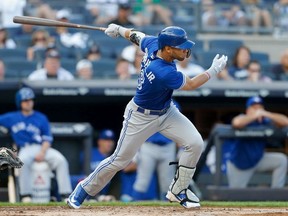 Lourdes Gurriel Jr. #13 of the Toronto Blue Jays follows through on a second inning RBI single against the New York Yankees at Yankee Stadium on September 15, 2018 in the Bronx borough of New York City.