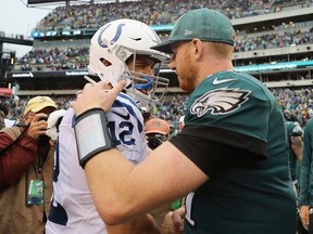 Quarterback Andrew Luck #12 of the Indianapolis Colts talks with quarterback Carson Wentz #11 of the Philadelphia Eagles after the Eagles 20-16 win at Lincoln Financial Field on September 23, 2018 in Philadelphia, Pennsylvania.