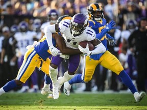 Wide receiver Laquon Treadwell #11 of the Minnesota Vikings is tackled by defensive back Lamarcus Joyner #20 of the Los Angeles Rams after his catch in the first quarter at Los Angeles Memorial Coliseum on September 27, 2018 in Los Angeles, California.