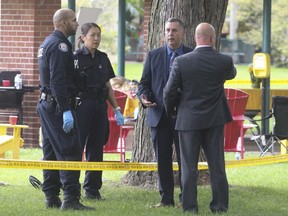Toronto Police officers on the scene after the murder of Michael Lewis at Coronation Park. (Jack Boland, Toronto Sun)