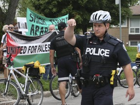 Toronto Police keep two groups -- one pro-Palestinians, the other pro-Israeli -- apart in front of a B’nai Brith building in North York on Aug. 29, 2018. (Veronica Henri, Toronto Sun)