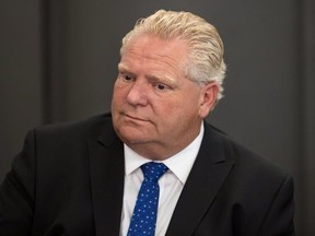 Ontario Premier Doug Ford attends a meeting with Toronto Mayor John Tory, Minister of Border Security and Organized Crime Reduction Bill Blair, and Toronto Police Chief Mark Saunders at City Hall in Toronto on Monday, July 23, 2018. THE CANADIAN PRESS