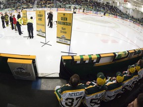 Humboldt Broncos look on as first responders unveil a banners during a tribute to the team after their SJHL game against the Nipawin Hawks on Wednesday. (THE CANADIAN PRESS)